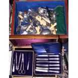 A quantity of silver plated cutlery, including a ladle, dinner forks, knives, mother-of-pearl
