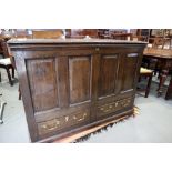 An 18th century oak mule chest with panelled front and plank top, on bracket feet, 48" wide x 34"