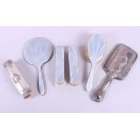 A blue enamelled silver dressing table set, together with a silver backed mirror and clothes brush