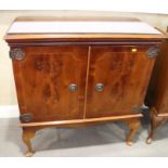 A figured yew side cabinet, on cabriole supports, 32" wide