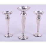 A pair of Edwardian silver vases with pierced flared rims, on weighted bases, 6 1/2" high, and a