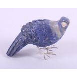 A carved lapis model of a bird with garnet eyes and agate beak, 3" high