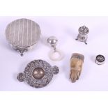 A silver tea strainer, a silver pill box with tortoiseshell top, a silver baby's rattle, a silver