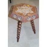 A late Victorian carved oak hexagonal top occasional table, on bobbin turned supports, 20" wide