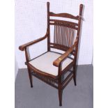 An American open armchair with thirteen spindles to back and wooden seat with upholstered panel, and