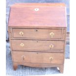 A Georgian oak bureau with fitted interior over three graduated drawer, on bracket feet, 30" wide