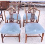 A set of four 19th century mahogany pierced splat back dining chairs with stuffed over seats, on