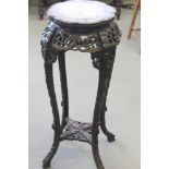 A Chinese carved hardwood and marble inset top jardiniere stand, 36" high