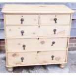 A pine chest of two short and three graduated drawers, on bun feet, 37 1/2" wide x 36 1/2" high