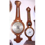 An oak cased barometer and another with a circular central mirror