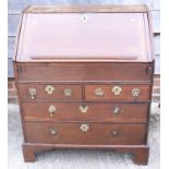 An 18th century oak provincial fall front bureau with fitted interior with well, over two drawers