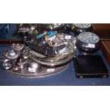 An oval silver plated gallery tray, a three-light table candelabra, a plated engraved cake basket, a