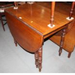 An Edwardian mahogany dropleaf table, on turned and tapering supports, 36" wide x 20" deep