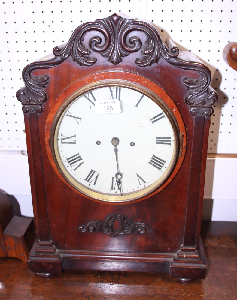 An early 20th century mahogany cased bracket clock with white painted dial and Roman numerals, 19"