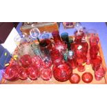 A set of six cranberry glass wines, six cranberry glass pony tumblers, two cranberry jugs and