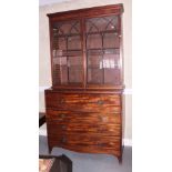 A late Georgian mahogany secretaire bookcase, the upper section enclosed two Gothic lattice glazed