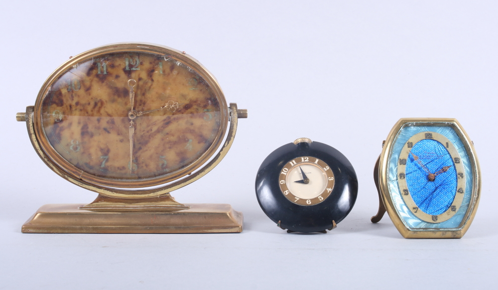 An Art Deco brass cased mantel clock with faux tortoiseshell dial, a brass cased travel alarm
