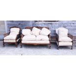 An early 20th century walnut and mahogany bergere settee and armchair, on cabriole supports,