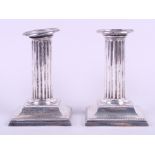 A pair of silver Corinthian column candlesticks with weighed bases, 4 3/4" high