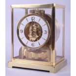 A gilt and glass cased Jaeger-LeCoultre Atmos mantel clock with white enamel dial and Arabic and