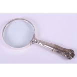 An embossed silver-handled magnifying glass
