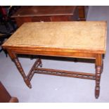 A Victorian walnut fold-over card table with turned and tapered supports, on galleried 'H'