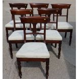 A set of six George IV mahogany dining chairs with central carved splat, in the form of a tulip,