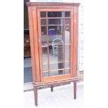 An oak corner cupboard with glazed door enclosed three shelves, 20" across x 67 3/4" high