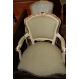 A pair of French grey painted and gilt decorated open armchairs with stuffed over seats, on cabriole
