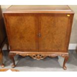 A walnut side cabinet, on cabriole supports, 30" wide