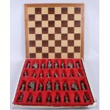 A chess set with white and brass coloured pieces