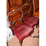A pair of mid 19th century carved rosewood loop back standard dining chairs with stuffed over seats,