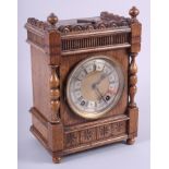An Edwardian oak cased mantel clock with gilt dial, silvered chapter ring, Roman numerals and