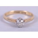 An 18ct gold, platinum and diamond solitaire ring, size M