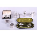 An assortment of silver including napkin rings, a mustard pot, a toast rack and other items, 10.
