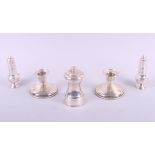 A pair of silver pepperettes, 2.2oz troy approx, a pair of filled silver candlesticks and a silver