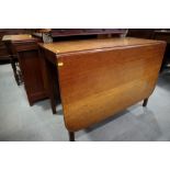 A 19th century mahogany drop leaf dining table, on square taper supports, 40" wide