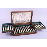 An oak cased canteen of silver plated fish knives and forks