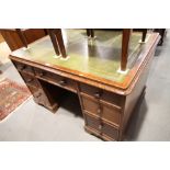 A partners Victorian mahogany double pedestal desk with tooled green leather lined top, fitted seven