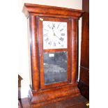 A mahogany cased Vienna wall clock with white painted dial and Arabic numerals above a mirrored