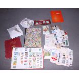 Four stamp albums containing stamps from around the world, a quantity of loose stamps, and a