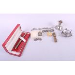 A white metal charm bracelet, a Sheaffer fountain pen, a white metal condiment box, a silver