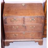 A late Georgian oak bureau, fitted two short and two long drawers, 36" wide