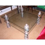 An Indian embossed and enamelled white metal mounted glass two-tier coffee table, 42" square x 19"