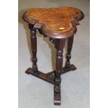 A Tudor Revival trefoil top stool, on fluted supports, 16" wide