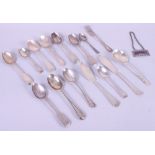 A quantity of silver spoons, a sherry label, a butter knife and other cutlery, 11.4oz troy approx