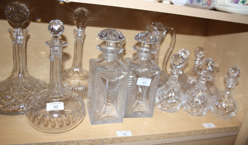 A pair of cut glass spirit decanters, a ships decanter, four onion-shaped decanters and five other