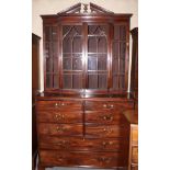 A George III mahogany breakfront secretaire bookcase, the upper section enclosed Gothic lattice