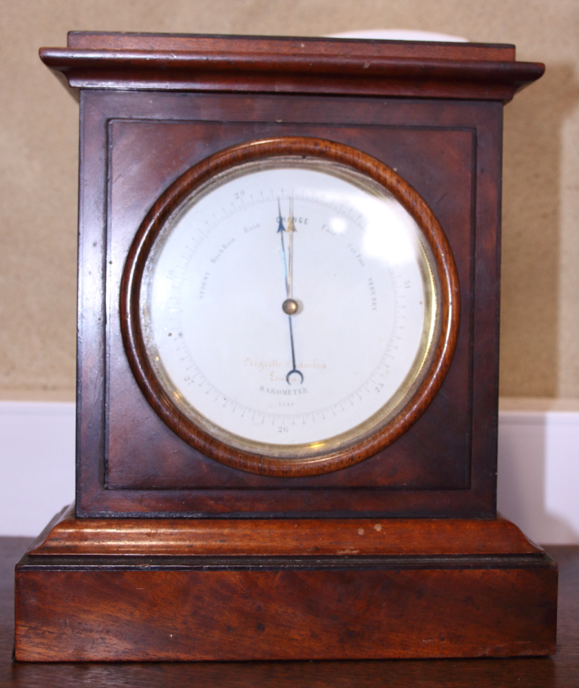 A Negretti and Zambra aneroid barometer, in figured mahogany and ebony line inlaid case, 9 1/4"