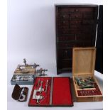 A twenty-drawer clock maker's chest, containing watch parts, various tools, including a small